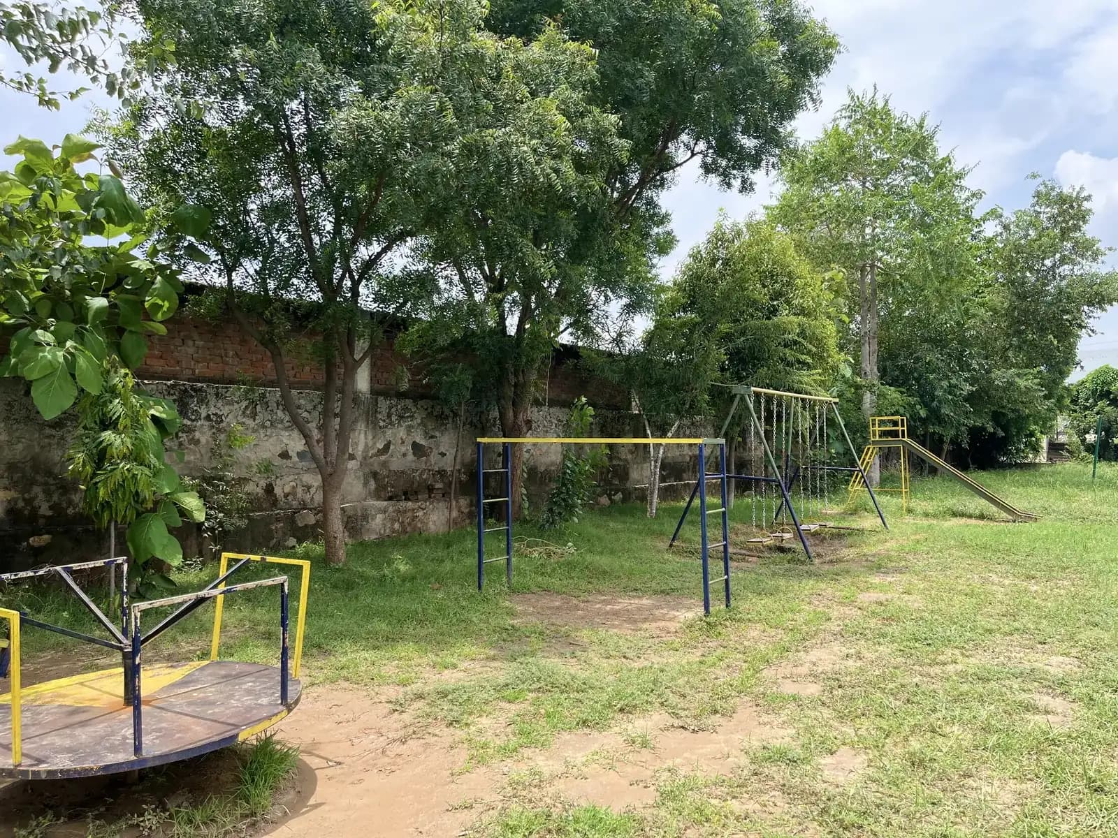The school playground with its swings and climbing frame
