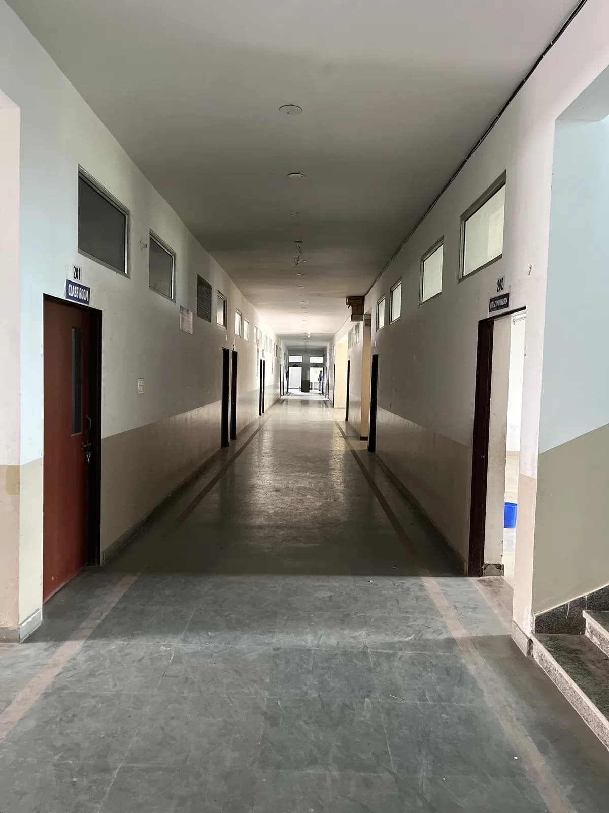 A corridor lined with classrooms inside the school