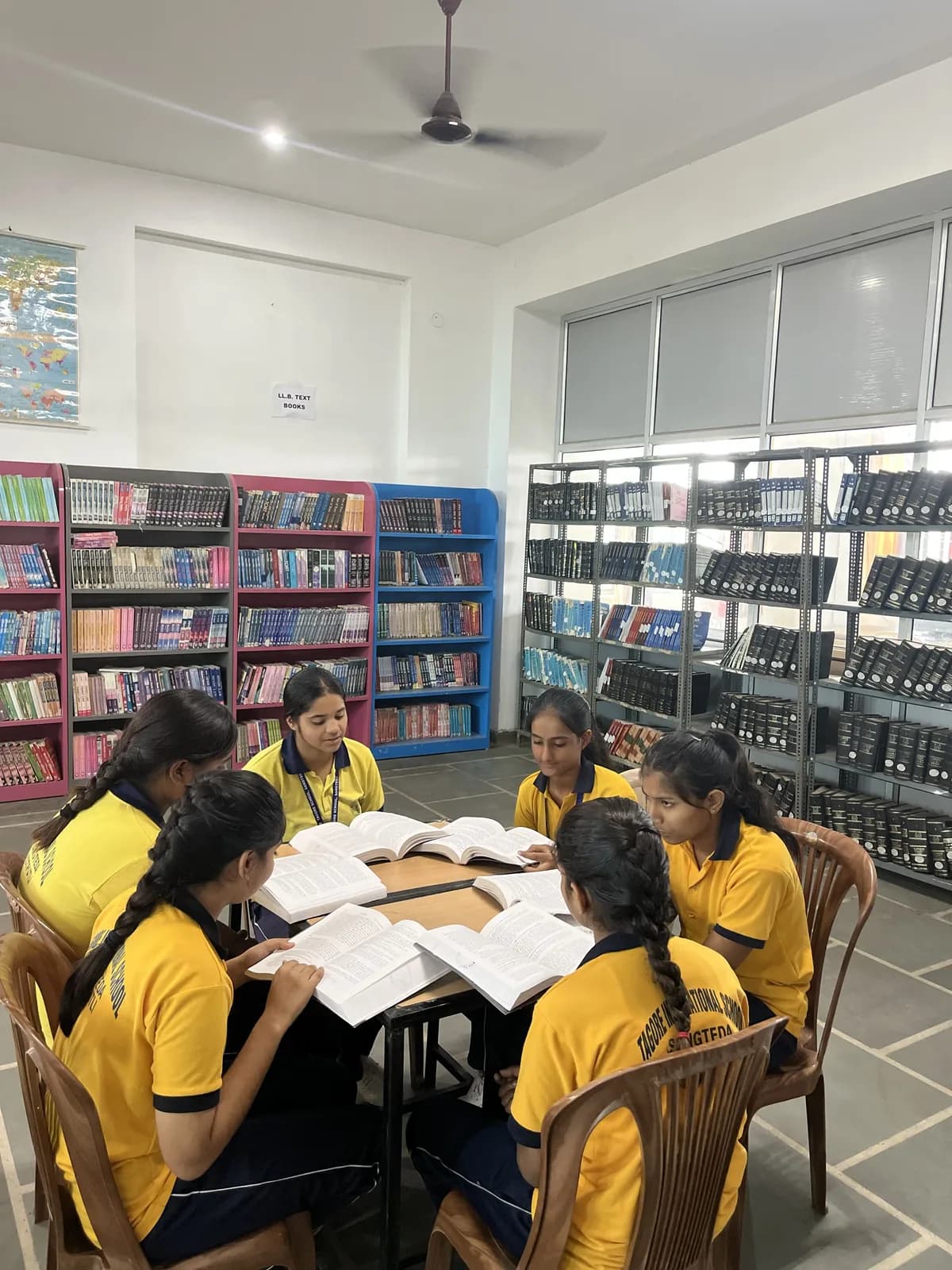Students reading together at a table in the school library